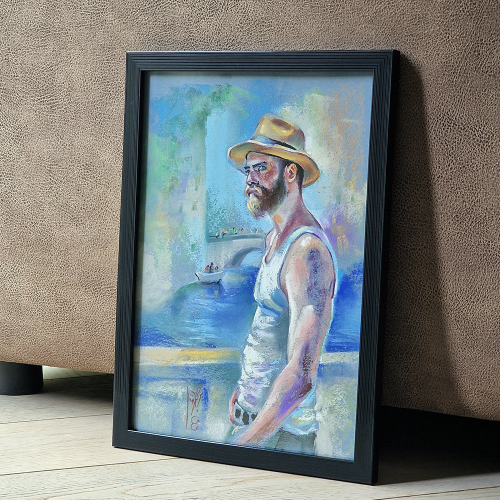 Framed painting of a man with a hat and beard standing by a body of water.